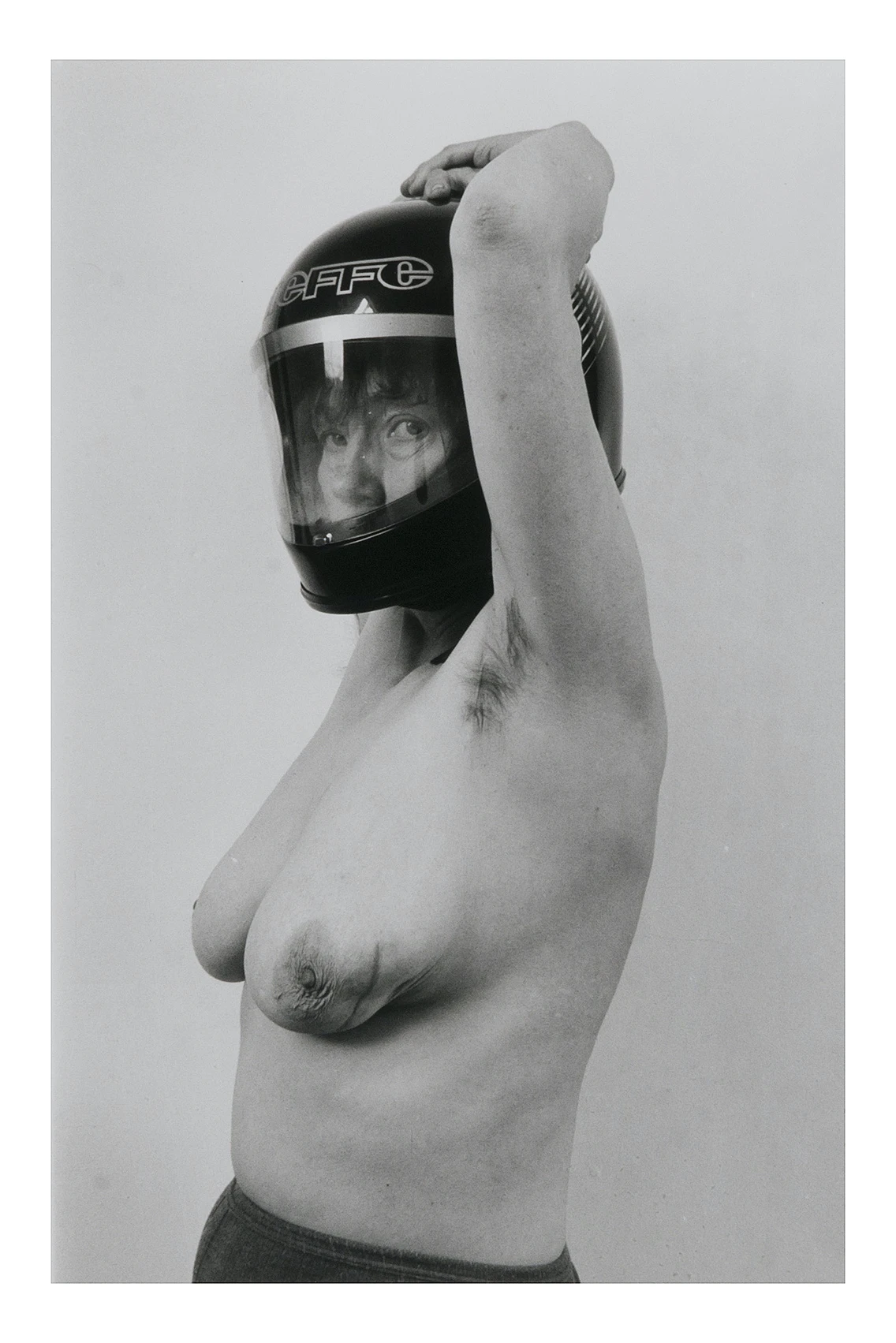 Jo Spence wearing a helmet (1982)